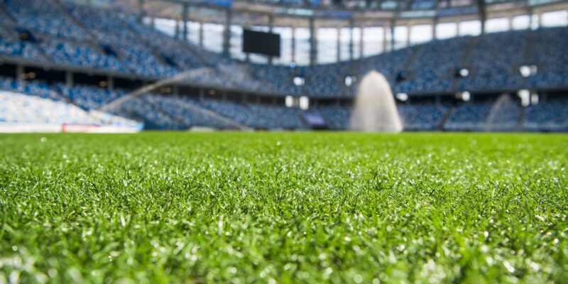 Irrigation turf. Sprinkler watering football field.