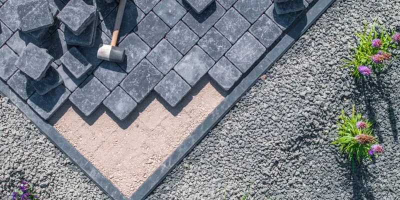 Laying Paving Stones in a Garden Pathway on a Sunny Day